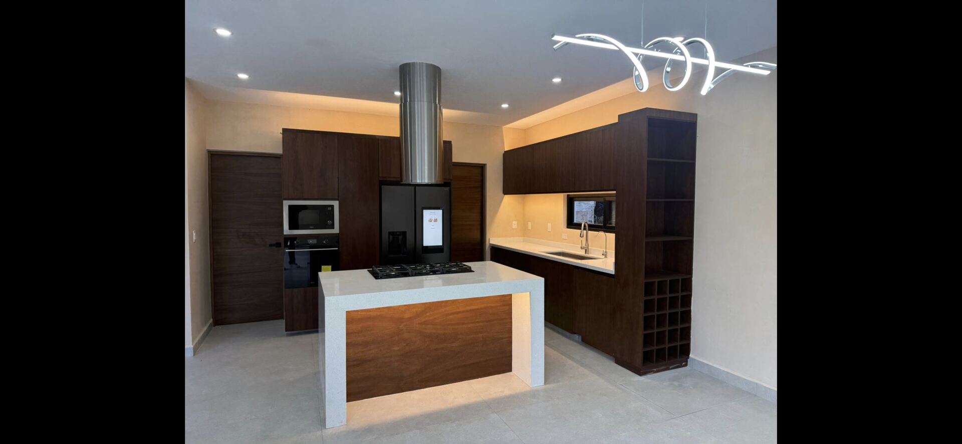 Walnut chef's kitchen with marble island